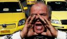 Ein Taxifahrer in Athen ruft während eines Streiks Parolen. Die Taxifahrer der griechischen Hauptstadt haben sich zu einem zweitägigen Streik zusammengefunden, um gegen die geplanten Steuerreformen der Regierung zu protestieren.  Foto: dpa