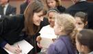 French First lady Carla Bruni-Sarkozy meets children as she visits the Paris book fair, Friday, March 18, 2011 in Paris. Carla Bruni-Sarkozy's foundation try to fight against illiteracy by giving books to children.  (AP Photo/Lionel Bonaventure, Pool) Foto: ap