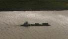 A shrimp boat, bottom, heads up the Mississippi River from the Gulf of Mexico in Port Eads, La., Thursday, April 29, 2010. The seafood industry is vulnerable to the looming oil spill from last week's collapse and spill of the Deepwater Horizon oil rig. (AP Photo/Gerald Herbert) Foto: AP