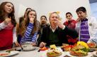 Moderator Johannes B. Kerner (Mitte) beißt beim Start der Gut-drauf-Pausenbrot-Initiative in der Wedding-Schule in Berlin zusammen mit den Schülern Seyma, Sara Julia, Ceyda, Bünyamin und Erdem (von links) in ein Pausenbrot. Ein Wursthersteller startete am gleichen Tag die bundesweite Aktion für gesunde Schulernährung. Foto: dpa