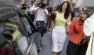 Debrahlee Lorenzana, center, a woman who says she was fired from her banking job after complaining that male colleagues called her curvaceous figure distracting, and her attorney Gloria Allred, right, walk to a waiting car after a curbside news conference in New York's Financial District, Monday, June 28, 2010. (AP Photo/Richard Drew) Foto: ap