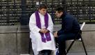 Während einer Freiluft-Messe in Madrid nimmt ein Priester einem Gläubigen die Beichte ab. Foto: dpa