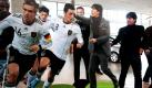 Bundestrainer Joachim Löw (rechts) geht bei seiner Ankunft zur Pressekonferenz an lebensgroßen Pappaufstellern verschiedener Nationalspieler und sich selbst vorbei. Im Rahmen der EM-Qualifikation spielt die deutsche Fußball-Nationalmannschaft am Freitag in Berlin gegen die Mannschaft der Türkei und am Dienstag in Astana gegen das Team aus Kasachstan. Foto: dapd