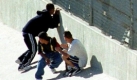 A group of emigrants crouch upon detection by US Border Patrol Officers,02 May 2003, as they try to cross the border from Mexico into the United States. US Government approved new measures to investigate, arrest and deport people whos' stay in the country is considered illegal, in which different agencies like the FBI will participate. Foto: dpa