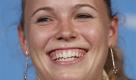 Women's world number one Denmark's Caroline Wozniacki smiles during a press conference at the Sydney International tennis tournament in Sydney, Australia, Sunday, Jan. 9, 2011. (AP Photo/Mark Baker) Foto: ap