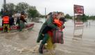 A fire rescue worker carries a man through the flooded streets of Sandomierz, Poland, where Vistula river burst its banks, 19 May 2010. Torrential rains brought severe flooding to southern Poland in which five people lost their lives so far.
 Foto: dpa