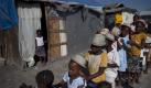 On their way to a prayer meeting, children line up at refugee camp in Port-au-Prince, Haiti, Wednesday Jan. 12, 2011. Thousands gathered around the city to be with loved ones and pray. Wednesday marks the one-year anniversary since Haiti's magnitude-7.0 earthquake that devastated the capital and is estimated to have killed more than 230,000 people and left millions homeless. (AP Photo/Ramon Espinosa) Foto: ap