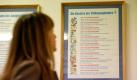 Eine Besucherin des Schulmuseums Leipzig betrachtet am Dienstag (30.09.08) in einem Klassenzimmer aus DDR-Zeiten die Gesetze der Thaelmannpioniere. Das Schulmuseum sammelt Material zur Schulgeschichte sowie Unterrichtsmittel aus verschiedenen Jahrhunderten. Besucher koennen verschiedene Unterrichtssituationen aus der Vergangenheit miterleben. Foto: ddp