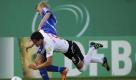 Durchgesetzt: Der Cottbusser Dimitar Rangelov (vorn) und Kiels Dan Poggenberg kämpfen um den Ball.Am Ende behielt der Regionalligist gegen den ambitionierten Zweitligisten mit 3:0 die Oberhand. Foto: dapd