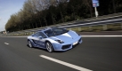 A Lamborghini police car of the Italian Traffic Police, with a top speed of 325 kilometers per hour (202 mph), drives on the motorway near the city of Ewijk, eastern Netherlands, Friday Oct. 9, 2009. The car is the top attraction at a display of Dutch Police and emergency services in Ewijk, Saturday Oct. 10th. The car is equipped with the latest gadgetry, such as a medical platform under the hood that contains a cold box for transferring human donor organs and a camera up front to record GPS data. The car was one of several that has been donated by its builders to Italian police. The 2008 model updated two cars Italian police received in 2004. (AP Photo/Peter Dejong) Foto: ap