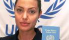 American actress Angelina Jolie poses for photographers in front the UNHCR logo with her UN passport during a ceremony at the United Nations Hight Commissioner for Refugees, UNHCR, headquarters in Geneva, Switzerland, Monday, August 27, 2001. American actress Angelina Jolie will help bring awareness about refugees as the U.N. refugee agency's Goodwill Ambassador. At a ceremony this Monday with staff at UNHCR headquarters in Geneva, the 26 year-old Jolie will be given the honorary title by Mr. Ruud Lubbers, UN High Commissioner for Refugees. dpa Foto: dpa