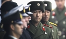 A North Korean soldier looks at South Korean side during the repatriation ceremony for a North Korean army sergeant as the United Nation honor guards stand at the border village of the Panmunjom (DMZ) that separates the two Koreas since the Korean War, north of Seoul, South Korea, Wednesday, Wednesday, Dec. 2, 2009. The North Korean officer was plucked from a small boat that drifted last Sunday into South Korean waters off the west coast. (AP Photo/Ahn Young-joon) Foto: ap