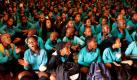 Kinder einer Schule in Johannesburg haben sich für ein gemeinsames Lied in einer Halle versammelt und begehen damit ihren ersten Schultag nach den Ferien.  Foto: dapd