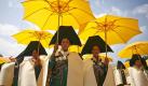 Chinese Yi ethnic women wearing traditional dresses hold yellow umbrellas during a parade celebrating the annual Torch Festival in Xichang, in southwest China's Sichuan province, Wednesday, Aug. 4, 2010. The Torch Festival, celebrated on the 24th or 25th day of the sixth month of the Yi calendar, is one of the major holidays celebrated by Yi and some other ethnic groups in southwest China. (AP Photo) ** CHINA OUT ** Foto: ap