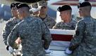 A member of a Marine carry team salutes, center, as an Army carry team carries a transfer case containing the remains of Army Spc. Matthew Hennigan, of Las Vegas, Friday July 2, 2010, at Dover Air Force Base, Del. According to the Department of Defense, Hennigan died while supporting Operation Enduring Freedom in Afghanistan. (AP Photo/Cliff Owen) Foto: ap