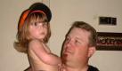 In this undated photo released by the Hartley Family, Karl Kleppinger Jr. holds his 2-year-old niece Kaitlyn Hartley in McComb, Miss. Kaitlyn is wearing Karl's Tony Stewart cap. Karl was a fan of the NASCAR driver Tony Stewart. He is among 11 oil rig workers from the Deepwater Horizon missing and presumed dead. (AP Photo/Courtesy of Hartley family) NO SALES Foto: AP