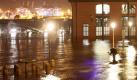 In stürmischer Nacht: Fotograf bei der Arbeit auf dem Fischmarkt in Hamburg. Foto: Bodo Marks Foto: dpa