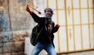 Ein palästinensischer Junge wirft in Hebron einen Stein auf israelische Soldaten. Grund für die Auseinandersetzungen ist die Entscheidung Israels, zwei heilige Stätten im Westjordanland als israelisches Nationalerbe zu beanspruchen. Foto: ap