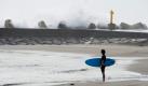 Ein japanischer Surfer schaut auf die hohen Wellen, die der Taifun Ma-On verursachte. Mit dem tropischen Wirbelsturm sind sintflutartige Regenfälle verbunden. Die japanischen Inseln Shikoku und Honshu bekommen Ma-On noch zwischen dem 19. und 20.Juli zu spüren. Foto: dpa