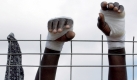 The injured hands of an African immigrant raised above the fence of the CETI (Temporary Home for Immigrants) in the Spanish North African enclave of Melilla, on Wednesday 19 October 2005. Spain has increased pressure on Morocco to stem the tide of illegalsafter thousands attempted to storm Ceuta and Melilla in recent months, bringing Spanish reception structures to the verge of collapse.  Foto: dpa