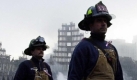 One month after the terrorist attacks on the World Trade Center, firefighters walk past the wreckage to a memorial service 11 October, 2001, in New York. A short ceremony marking the attack was held at ground zero of the World Trade Center ruins. Construction workers, police officers and firefighters took off their helmets as work on the giant demolition site ground to a halt in memory of the more than 5,200 people dead or missing following the collapse of the twin towers one month ago today. dpa Foto: dpa