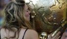 A Dutch soccer fan kisses a replica of the World Cup trophy prior to the World Cup quarterfinal soccer match between the Netherlands and Brazil at Nelson Mandela Bay Stadium in Port Elizabeth, South Africa, Friday, July 2, 2010. (AP Photo/Frank Augstein) Foto: Fans