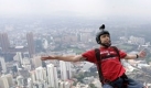 An unidentified BASE jumper leaps from the height of 300 meters of Malaysia's landmark KL Tower, the 421-meter (1,381-foot) broadcasting tower, in Kuala Lumpur, Malaysia, Saturday, Oct. 24, 2009. (AP Photo/Lai Seng Sin) Foto: ap
