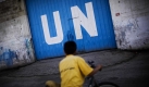 Ein palästinensisches Kind steht vor dem geschlossenen Tor des Distributionszentrum der Vereinten Nationen in Gaza. Tausende von Palästinensern streiken und fordern bessere Löhne und Arbeitsbedingungen . Foto: ap