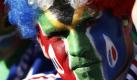 A supporter with the colors of the South Africa and France flags painted on his face waits for the start of the World Cup group A soccer match between France and South Africa at Free State Stadium in Bloemfontein, South Africa, Tuesday, June 22, 2010. (AP Photo/Francois Mori) Foto: ap