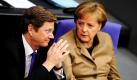 Außenminister Guido Westerwelle und Bundeskanzlerin Angela Merkel sitzen im Bundestag in Berlin. Bei der Debatte zum Afghanistan-Einsatz der Bundeswehr ist es zu einem Eklat gekommen. Abgeordnete der Linken hatten Plakate mit Namen von Opfern des Luftschlags vom 4. September 2009 in Kundus in Afghanistan hoch gehalten. Foto: ddp
