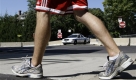 A pedestrian walks by a Chicago police vehicle and barricade, surrounding the home of President Barack Obama in Chicago, Wednesday, Sept. 16, 2009. Although Obama and the first family have spent little time in Chicago since packing their bags for the White House in January, their presence is still felt all around their old South Side neighborhood. (AP Photo/Charles Rex Arbogast) Foto: ap