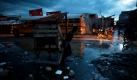 Ein Verkäufer zieht einen Karren durch die Straßen Port-au-Princes in Haiti, um seine Waren auf dem Wochenmarkt zu verkaufen. Foto: ap