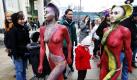 Models laufen als Reptilien angemalt über den Alexanderplatz in Berlin. Die Aktion einer Tierschutzorganisation soll auf die Haltung von exotischen Tieren in deutschen Wohnzimmern aufmerksam machen. Foto: dpa