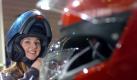 Model Jennifer posiert am Mittwoch (02.03.05) in den Messehallen in Dortmund auf der Messe 'Motorrad' mit einem Motorradhelm auf dem Kopf. Bis zum Sonntag (06.03.05) bietet die Motorradmesse in den Westfalenhallen Showvorfuehrungen, Sitzproben, Tuning, Technik und passendes Zubehoer fuer die motorisierten Zweiraeder. Foto: ddp