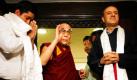 Tibetan spiritual leader the Dalai Lama, center, blesses people after receiving a book on Tibet authored by Parvez Dewan, right, and co-authored by Siddharth Srivastava, left, in New Delhi, India, Thursday, March 18, 2010. At an earlier gathering Thursday the Dalai Lama said he favored good relations between India and China to ensure peace in the region, according to a news agency. (AP Photo/Saurabh Das)  Foto: AP