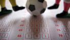 Ein Fußball und vier Spielerbeine auf einem Wettschein für Fußballbegegnungen (Foto vom 23.11.2009). Die ersten Geständnisse in Deutschland bringen langsam Licht ins Dunkel des Wettskandals. Doch die Ausmaße der Manipulationen gerade in Asien sind unüberschaubar.
 Foto: dpa
