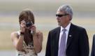 
Naomi Biden, left, takes pictures of her grandfather and U.S. Vice President Joe Biden as they arrive at the Chinggis Khaan International Airport in Ulan Bator, Mongolia, Monday, Aug. 22, 2011. (AP Photo/Andy Wong) Foto: dapd