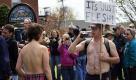 University of Maine at Farmington student Andrea Simoneau, left, is videotaped during a topless protest Friday, April 30, 2010, in Farmington, Maine. The demonstration called attention to the double-standard that it's acceptable for men, but not women, to go bare chested. In Maine, it's perfectly legal for women to go topless in public. (AP Photo/Robert F. Bukaty) Foto: ap