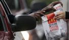 A customer grabs lunch at a McDonalds drive-through, Friday, Jan. 22, 2010, in Chicago. More hungry diners gobbling its cheap eats helped McDonald's Corp.'s sales and profit grow in its fourth quarter, the company said Friday in an earnings report showing it continued to weather the downturn better than many of its fast-food competitors.(AP Photo/M. Spencer Green) Foto: ap