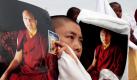 Exiltibeter in Indien zeigen mit Porträts ihres wichtigsten geistlichen Führers Ugyen Thinley Dorje, dass sie hinter ihm stehen. Indische Behörden ermitteln gegen ihn wegen der Herkunft von einer Million Dollar, die in dessen Sitz im Norden des Landes gefunden wurden.  Foto: dapd
