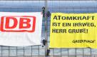 Aktivisten der Umweltschutzorganisation Greenpeace befestigen ein Banner der Deutschen Bahn und ein Banner mit der Aufschrift:  Atomkraft ist ein Irrweg, Herr Grube! am Glasdach des Berliner Hauptbahnhofes. Die Aktion richtet sich nach Greenpeace-Angaben gegen das Festhalten der Deutschen Bahn AG an Atomstrom. Foto: dapd