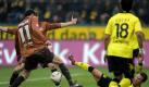 In der 49. Minute erhöhte St. Paulis Ralph Gunesch (links) mit einem Eigentor auf 2:0 für Borussia Dortmund. Foto: dpa