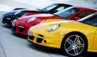 Ein schöner Anblick: Drei Sportwagen der Marke Porsche in den Farben der deutschen Nationalflagge stehen in Stuttgart vor dem Porsche-Museum. Foto: dpa