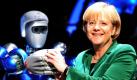 Bundeskanzlerin Angela Merkel hält auf dem Flughafen Berlin-Schönefeld während eines Rundgangs über die Internationale Luft- und Raumfahrtausstellung (ILA) die Hand des humanoiden Weltraumroboters Justin. Foto: ddp