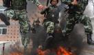 Special policemen of the local paramilitary force jump over a fire during their training in Bozhou, China, 28 July 2010. China has been stepping up security measures to deal with increasing social unrests in recent years. EPA/LIAO FA +++(c) dpa - Bildfunk++


 Foto: dpa