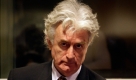 FILE -- In an Aug. 29, 2008 file photo former Bosnian Serb leader Radovan Karadzic, is seen in the courtroom at the U.N. Yugoslav war crimes tribunal in the Hague, Netherlands. The war crimes trial of Karadzic, who led the Bosnian Serbs through a brutal three-year civil war in the early 1990s, begins Monday Oct. 26,2009 about 15 months after he was captured in Serbia. (AP Photo/ Valerie Kuypers/file) Foto: AP