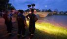 Feuerwehrleute beobachten mit Hilfe eines Lichtstrahlers den Wasserstand unter einer Brücke der Neiße in Bad Muskau. Seit Samstagnach wartet man dort bereits auf den Scheitelpunkt der Flut, der immer noch nicht eingetroffen ist. Foto: dpa