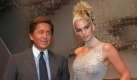 Italian designer Valentino and American top model Cindy Crawford pause for photographers 08 July prior to his 1997/98 Fall/Winter high fashion collection in Paris. She is wearing an asymmetrical sleeveless light blue evening dress with silver embroidery and a coordinated choker.
 Foto: dpa