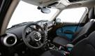 Im Interieur warten zunächst keine Überraschungen: das Cockpit entspricht in seiner Anordnung weitgehend dem des normalen Mini. Ins Auge fallen allerdings der Schubhebel-förmige Handbremsgriff und die Mittelkonsole, die aus zwei Schienen besteht und sich vom Handbremshebel bis in den Fond hindurch zieht. Foto: press-inform