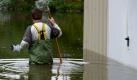 Wenige Tage nach Pfingsten hat das Hochwasser aus Polen Brandenburg erreicht. Sven Gumprecht steht am Donnerstag in einer Wathose im Hochwasser in Frankfurt (Oder). Der Pegel des deutsch-polnischen Grenzflusses soll bis zum Abend noch weiter ansteigen. Foto: dpa